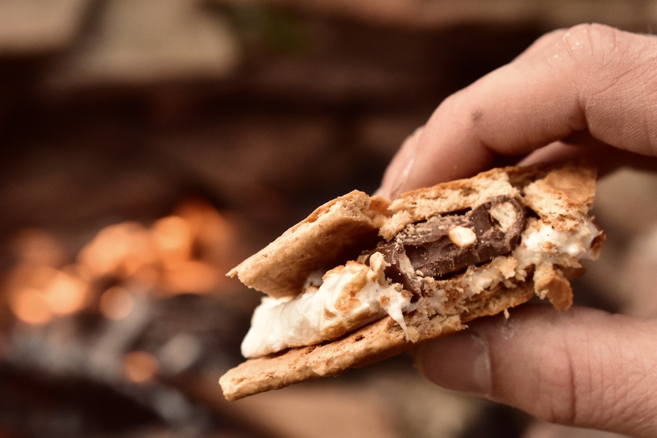 S'mores with chocolate-covered pretzel at campfire