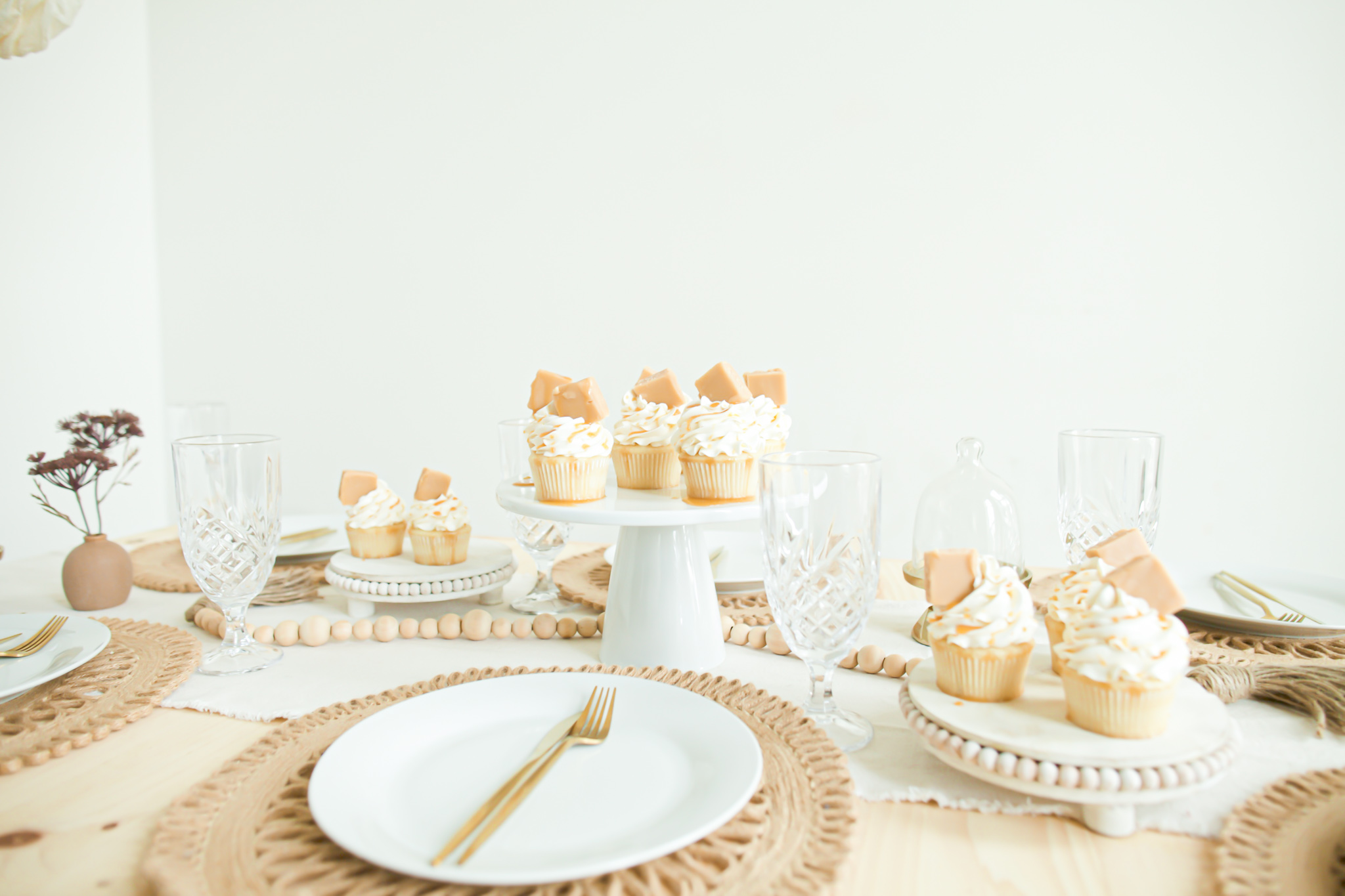 fall table decor and salted caramel cupcakes with white frosting and caramel drizzle