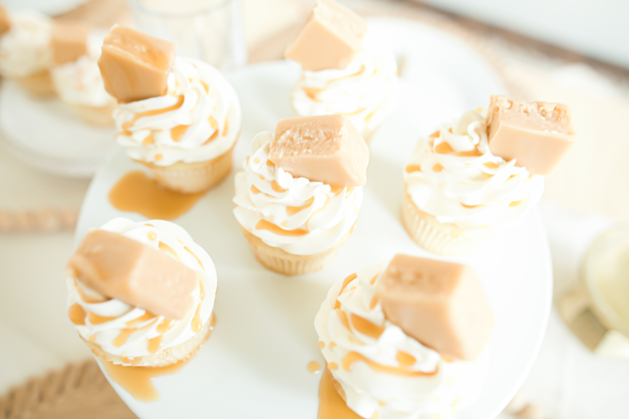 cupcakes on platter with vanilla fudge and caramel drizzle