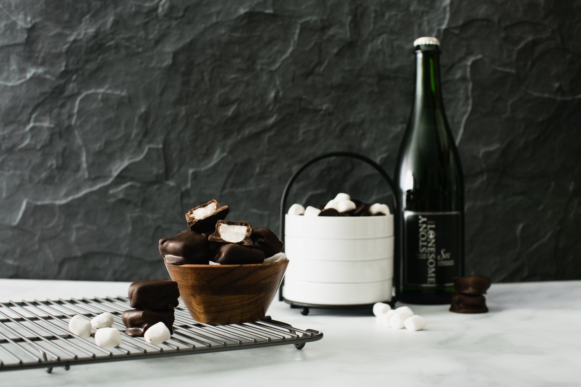 slate and marble kitchen setting with chocolate-covered marshmallows and chardonnay wine